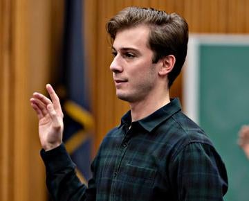 A student raises his hand during a class.